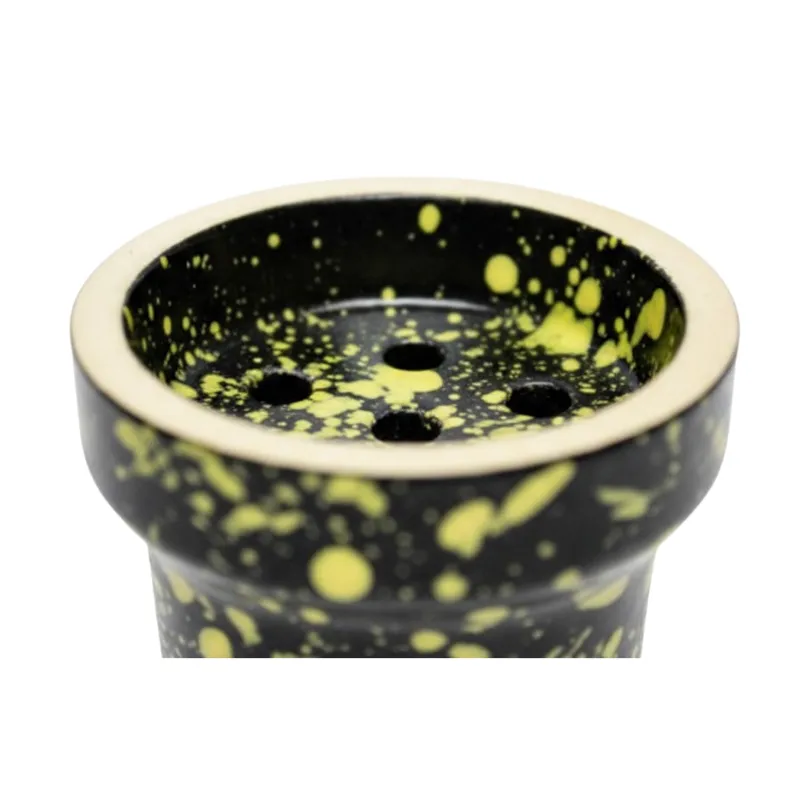 Cazoleta Elemento Fuego 2.0 Black Yellow fabricada en barro blanco poroso con esmalte de doble capa color negro y motas amarillas, azules y rojas, tipo tradicional con 7 agujeros y carga 15-17 gr en The Good Shisha